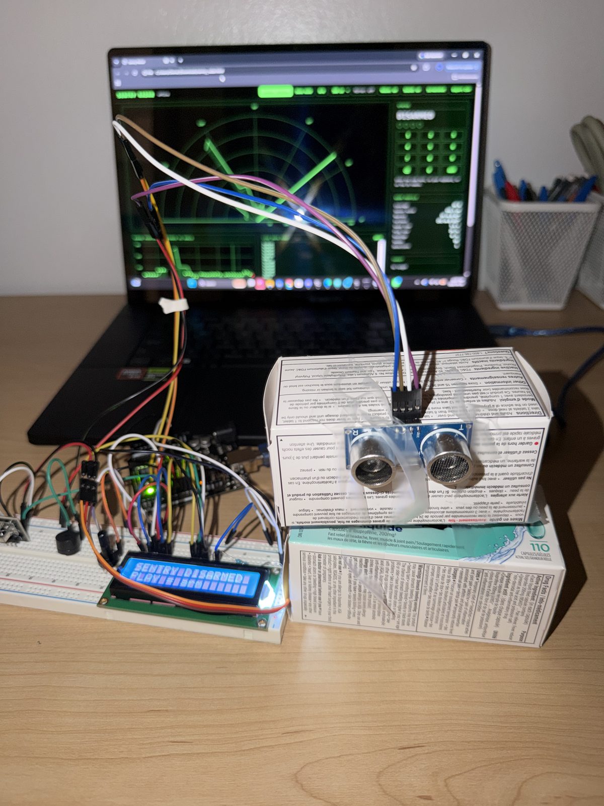 The turret. The servo in the lower box turns the upper box and the sensor, with the LCD in front and the dashboard behind.