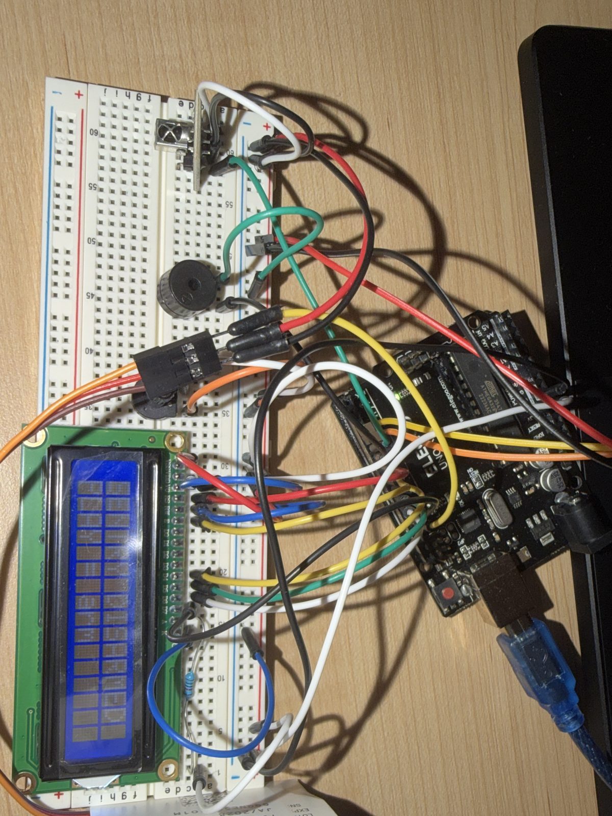 Arduino UNO, LCD1602, IR receiver and buzzer on the breadboard.
